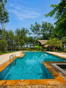 a swimming pool in the middle of a resort at The Cushty Days Lanta in Ko Lanta