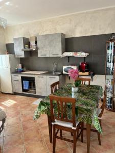 a kitchen with a table and chairs and a refrigerator at Il Casale Del Roero in Canale +21 photos