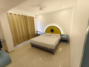 a bedroom with a bed with a face on it at The Moon Hotel Panvel in Āpta