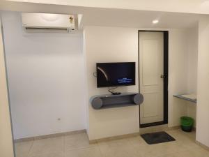 a room with a flat screen tv on a wall at The Moon Hotel Panvel in Āpta