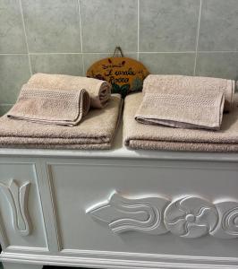 three towels sitting on a shelf in a bathroom at Il Casale Del Roero in Canale