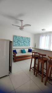a living room with a couch and a table and chairs at Solar de Manguinhos Flat in Manguinhos +49 photos
