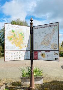 a street sign in front of a large map at Studio Catherine in Sainte-Céronne-lès-Mortagne