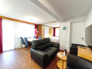 a living room with a couch and a table at Haus Primavera in Saas-Fee