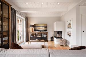 a living room with a couch and a fireplace at Reethaus Nordgold in Oldsum