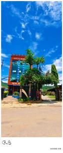 a building with a tree in front of it at Hotel Royal Inn in Nawākot