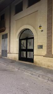 a building with a black gate on the side of it at Aire de sierra in Monachil