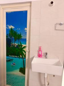 a bathroom with a sink and a view of the ocean at Pushpa Di Ghar in Kolkata