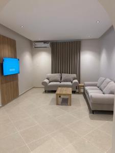 a waiting room with two couches and a flat screen tv at فيو بارك للاجنحة الفندقية in Al Kharj