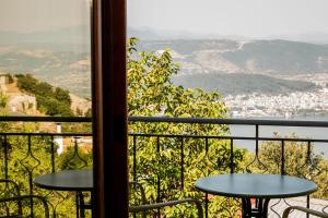 a balcony with tables and a view of a city at Ligiades 945 in Ligiades
