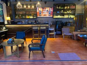 a bar with chairs and tables and a counter at Kalamung Resort and Pool villas in Ao Nang Beach