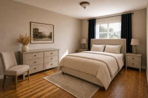 a bedroom with a bed and a chair and a window at TIMBER TRAIL RETREAT in Steamboat Springs