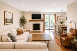 a living room with a couch and a fireplace at TIMBER TRAIL RETREAT in Steamboat Springs