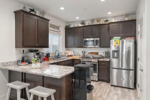 a kitchen with wooden cabinets and stainless steel appliances at Gonzolez Apartments in Zamboanga +12 photos