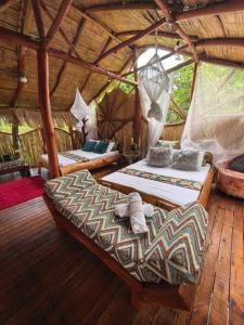 a bedroom with two beds in a tree house at Villa Sonia Eco-Hostel in Gigante