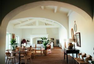 a dining room with tables and chairs in a room at Casas do Seixo - Monsaraz in Cabeça de Carneiro