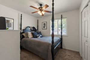 a bedroom with a bed with a ceiling fan at Gonzolez Apartments in Zamboanga