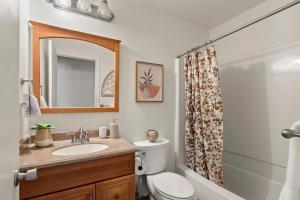 a bathroom with a sink and a toilet and a mirror at Gonzolez Apartments in Zamboanga