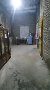 an empty room with a brick wall and a door at Mini outlit in Puloasem
