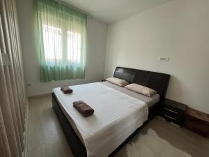 a bedroom with a bed with two towels on it at Rayand in Mostar