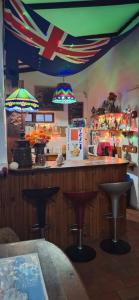 a kitchen with a bar with stools in a restaurant at Villa Ocean Crest B&B in Gansbaai