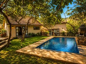 a swimming pool in the yard of a house at The Zarafa in Hazyview