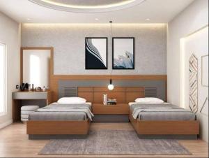 a large bedroom with two beds and a table at CHINDU HOUSE Inn in Chennai