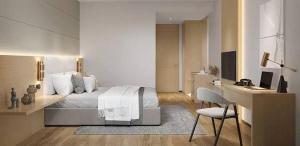 a bedroom with a bed and a desk and a chair at CHINDU HOUSE Inn in Chennai