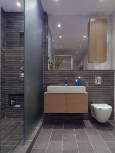 a bathroom with a sink and a toilet at CHINDU HOUSE Inn in Chennai +1 photo