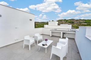 a white balcony with a table and white chairs at Sun & Moon Luxury - Celeste Villa in Ayia Napa