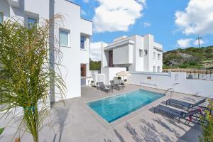 a villa with a swimming pool and a house at Sun & Moon Luxury - Celeste Villa in Ayia Napa