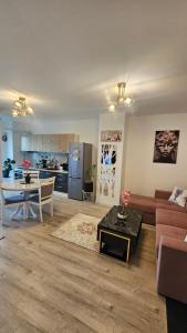 a living room with a couch and a table and a kitchen at Divine Luxury Rasnov in Râşnov