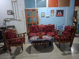 a living room with a couch and two chairs and a table at Terrace Camp inn in Tiruchirappalli