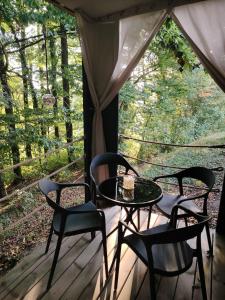 a patio with a table and chairs on a porch at Ranč na hribu in Trebnje