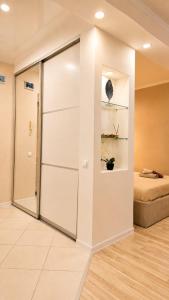 a sliding glass door in a room with a bed at Кошкарбаева 58 in Kokshetau
