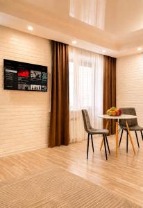 a room with a table and chairs and a window at Кошкарбаева 58 in Kokshetau