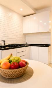 a bowl of fruit on a table in a kitchen at Кошкарбаева 58 in Kokshetau +3 photos