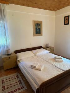 a bedroom with a bed with two towels on it at Vila Popovski in Ljubaništa