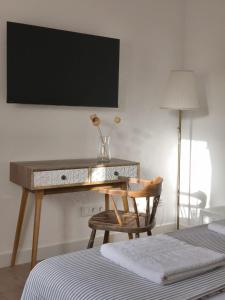 a desk in a bedroom with a chair and a bed at El Huerto de La Ermita in La Zubia