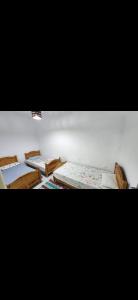 a room with three beds sitting next to each other at Immobilier Kimo in Tunis
