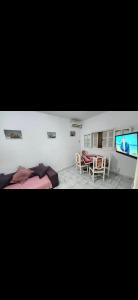 a bedroom with a bed and a table and a tv at Immobilier Kimo in Tunis