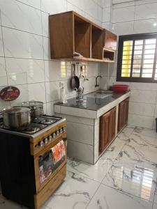 a kitchen with a stove and a counter top at At Home Bertoua in Bertoua