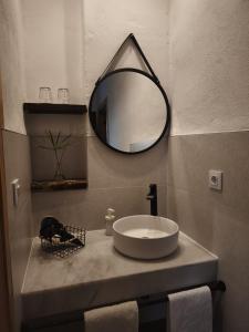 a bathroom with a sink and a mirror on a counter at El Huerto de La Ermita in La Zubia +33 photos