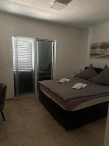 a bedroom with a bed and a sliding glass door at Villa Anni in Kremena +28 photos