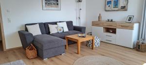 a living room with a couch and a table at Eichkobel-Blick in Grünenbach