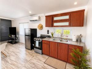 a kitchen with a black refrigerator and a sink at Finca Sol y Sal 