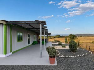a building with a pergola next to a field at Finca Sol y Sal 