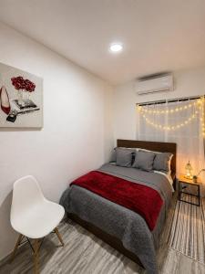 a bedroom with a bed and a white chair at Finca Sol y Sal 