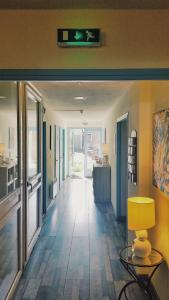 a hallway with a table and a clock on the wall at Hôtel Les Comtes de Pardiac in Marciac