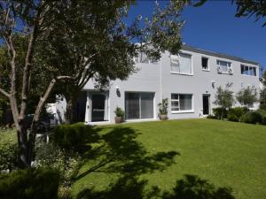 a large white house with a green yard at Lieflappie Seaview Stilbaai 400m to the beach in Stilbaai